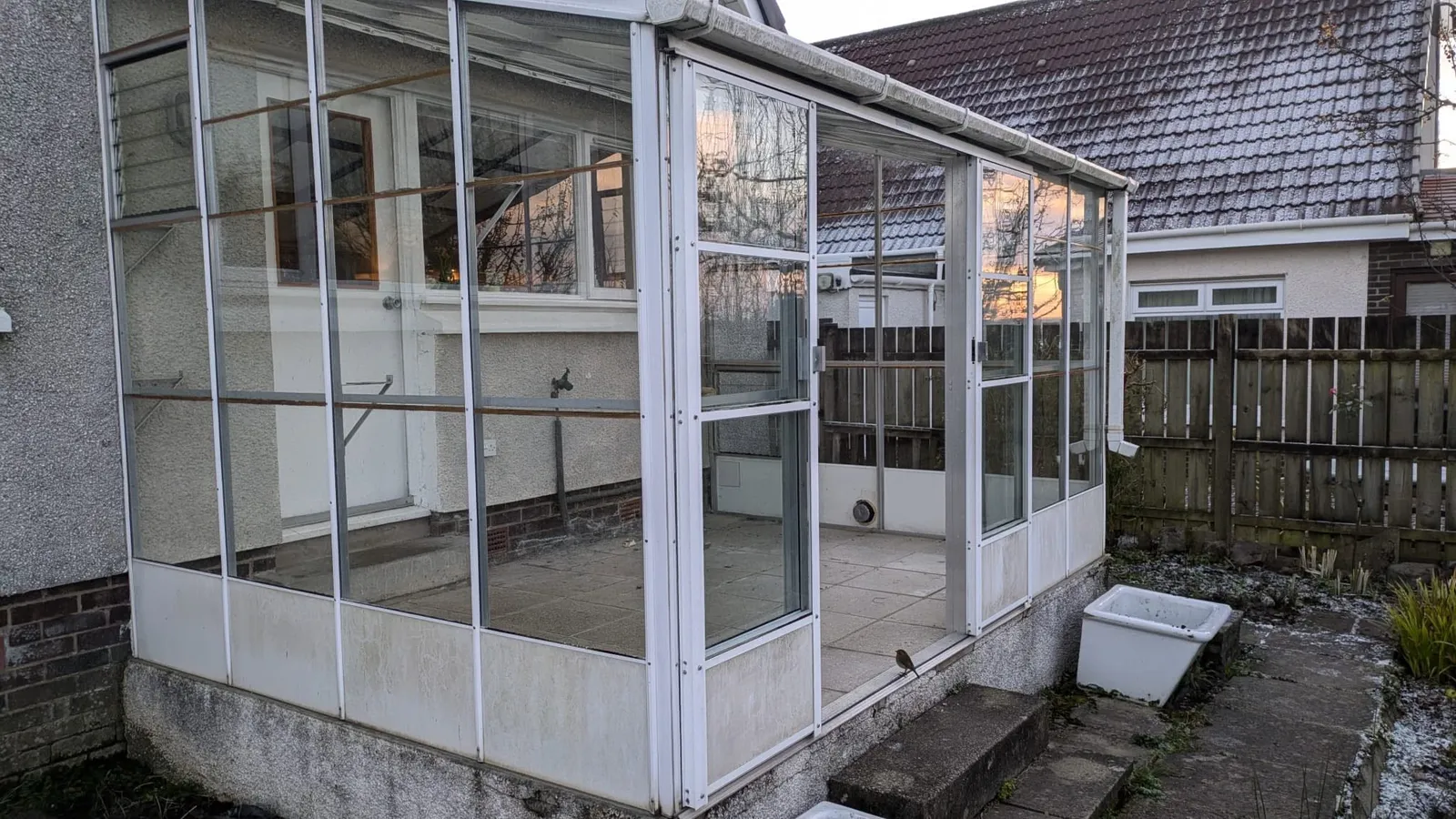 Before: the old lean-to conservatory this Penarth extension replaced — All Aspects Construction