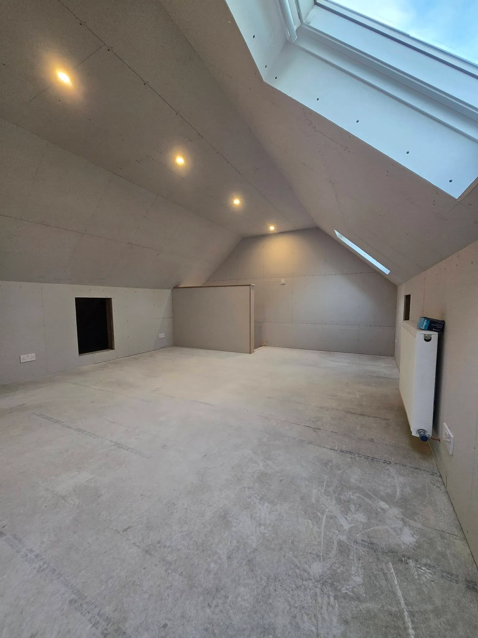 Loft conversion in Penarth: new room boarded out with roof windows — All Aspects Construction