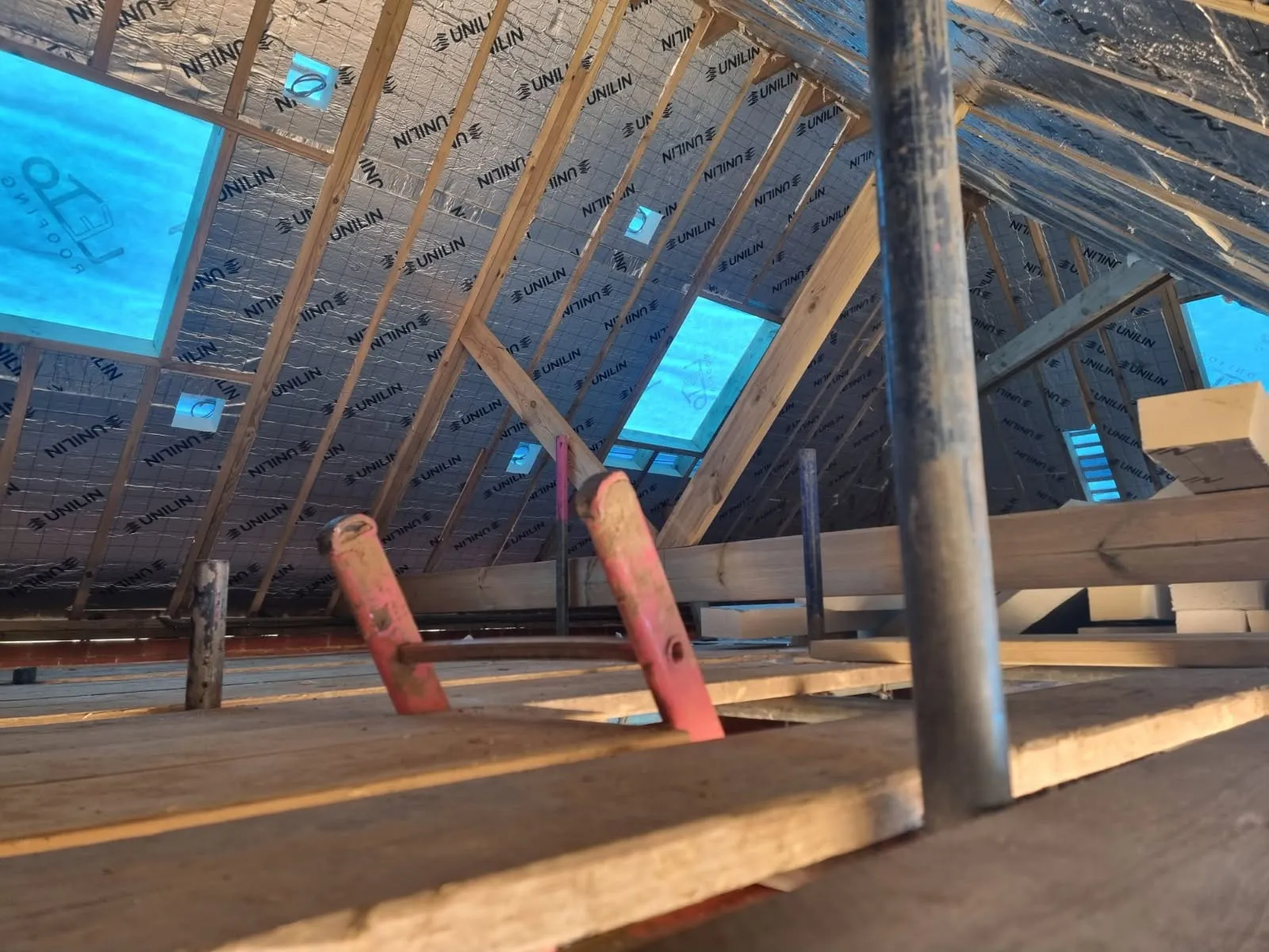 Loft conversion in Pontypridd: rafters insulated and roof window openings framed — All Aspects Construction