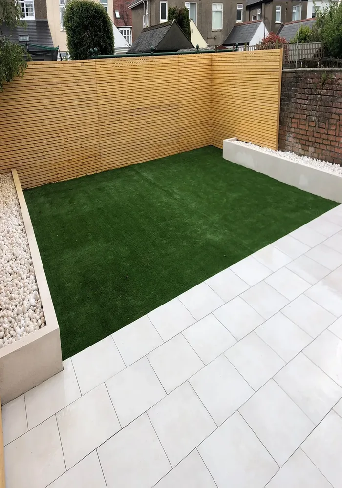 Garden with artificial lawn and porcelain paving — All Aspects Construction, Cardiff